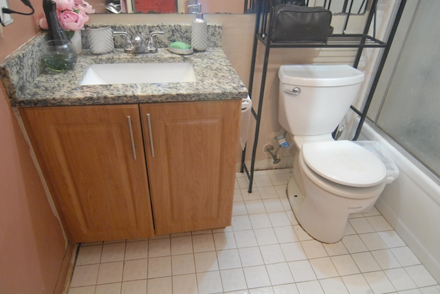 full bathroom with vanity, enclosed tub / shower combo, toilet, and tile patterned flooring