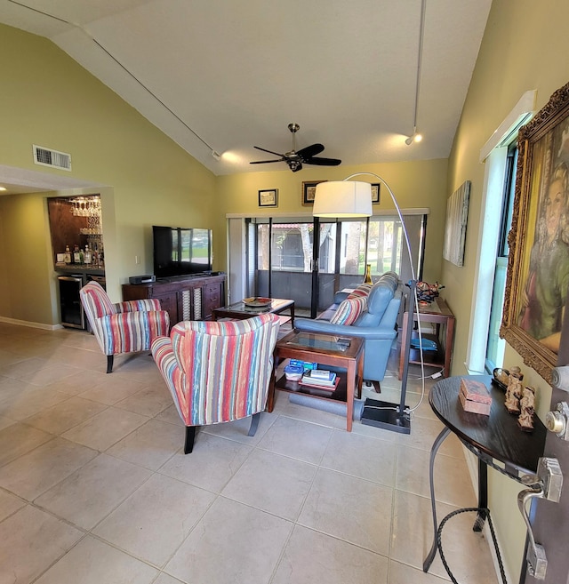 tiled living room featuring high vaulted ceiling and ceiling fan