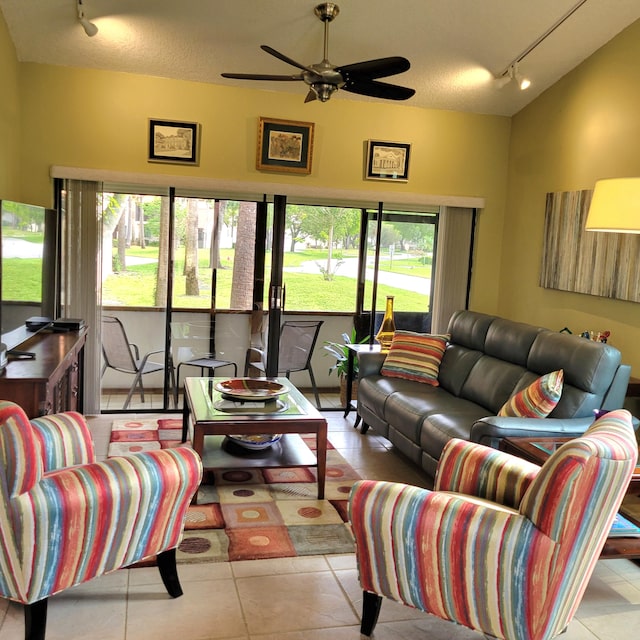 tiled living room with a textured ceiling, ceiling fan, track lighting, and a wealth of natural light