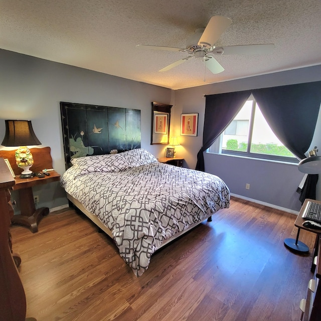 bedroom featuring a textured ceiling, hardwood / wood-style flooring, and ceiling fan