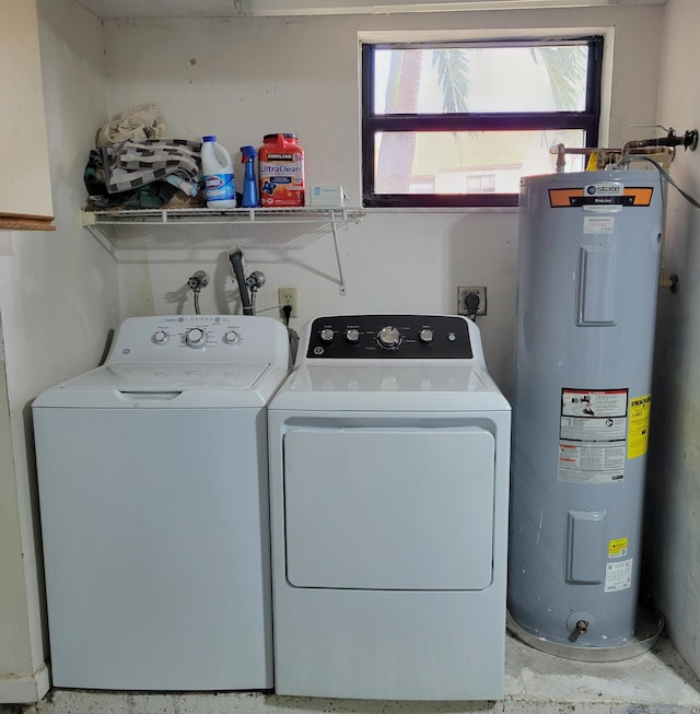 clothes washing area with electric water heater and washing machine and dryer