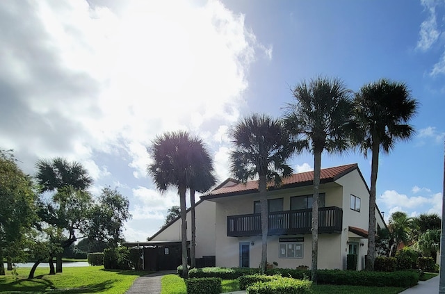 exterior space featuring a yard and a balcony