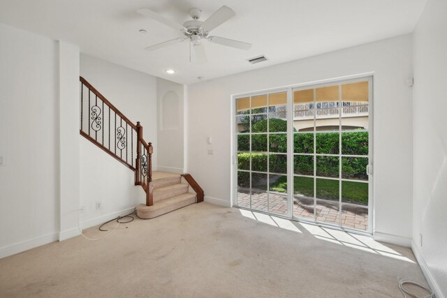 interior space featuring ceiling fan and light colored carpet