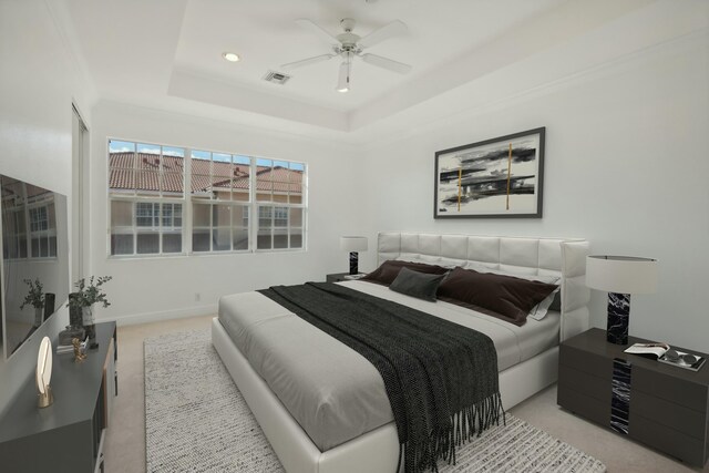 carpeted empty room featuring a raised ceiling, ceiling fan, and crown molding