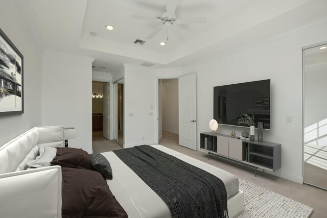 interior space with ceiling fan, a tray ceiling, and ornamental molding