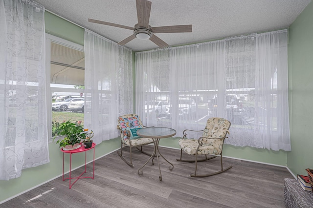 sitting room featuring a textured ceiling, hardwood / wood-style flooring, and ceiling fan