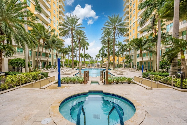 view of swimming pool featuring a patio and a community hot tub