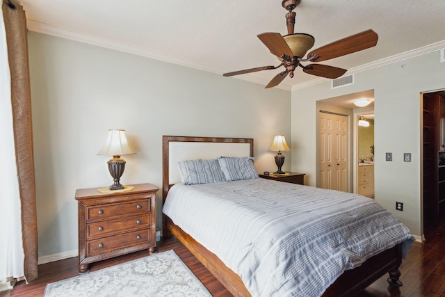 bedroom featuring dark hardwood / wood-style flooring, a closet, crown molding, and ceiling fan