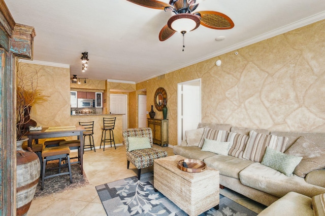 living room with crown molding, light tile patterned flooring, and ceiling fan