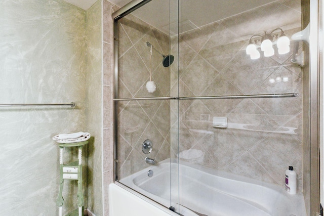 bathroom featuring combined bath / shower with glass door