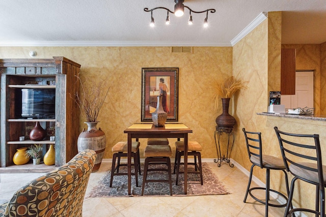 dining room with ornamental molding and a textured ceiling