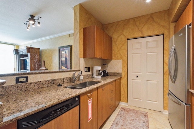 kitchen featuring light stone countertops, dishwashing machine, stainless steel refrigerator, crown molding, and sink