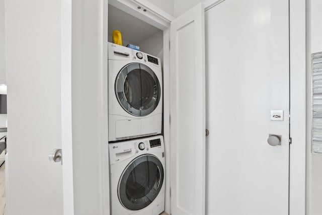 laundry room featuring stacked washer / drying machine