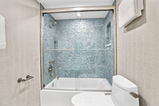 bathroom with enclosed tub / shower combo and toilet