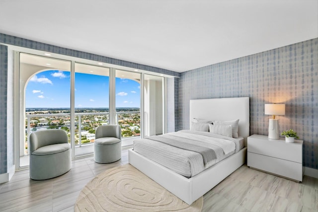 bedroom featuring floor to ceiling windows and access to exterior