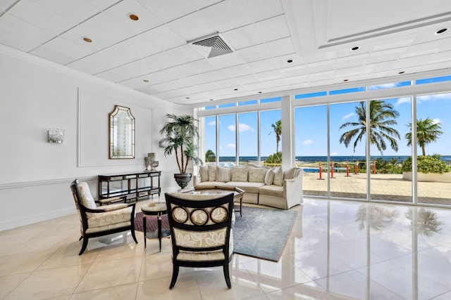 interior space featuring a healthy amount of sunlight, light tile patterned floors, a water view, and crown molding