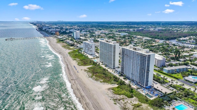 drone / aerial view with a water view and a beach view