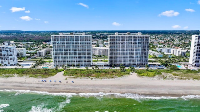 drone / aerial view featuring a view of the beach and a water view