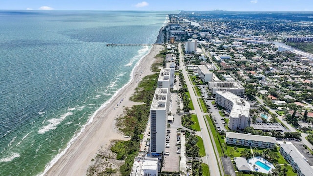 drone / aerial view featuring a water view and a view of the beach