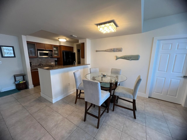 dining area with light tile patterned floors