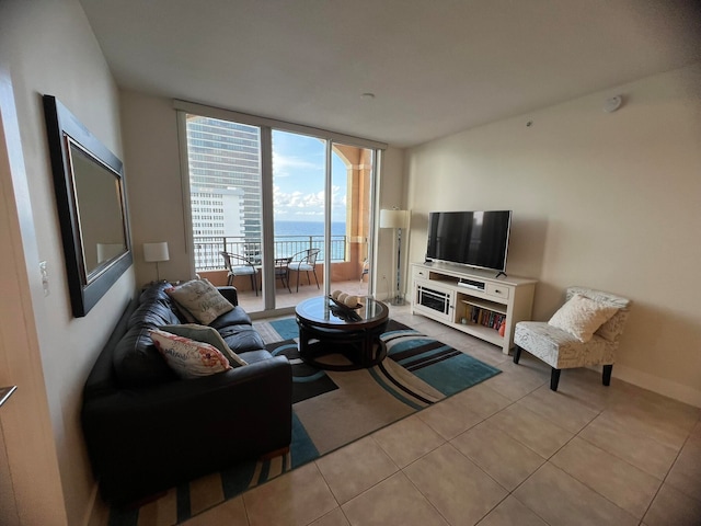 tiled living room featuring a wall of windows