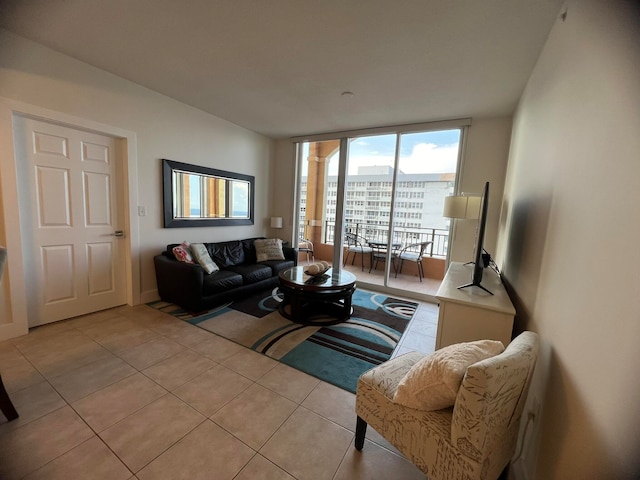 living room with floor to ceiling windows and light tile patterned floors