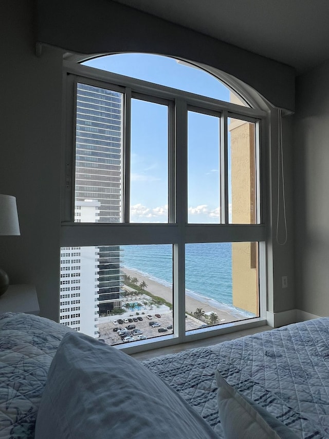 bedroom with a view of the beach and a water view