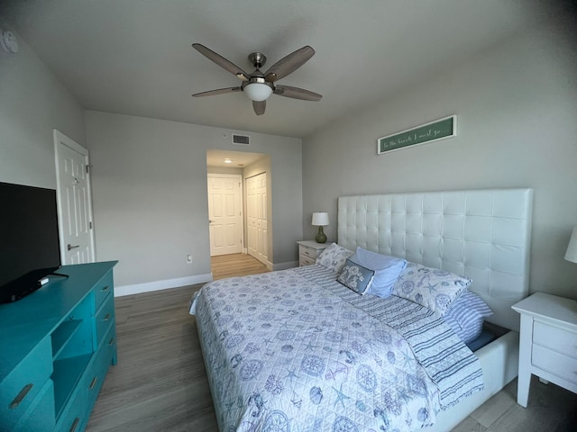 bedroom featuring a closet, ceiling fan, and dark hardwood / wood-style flooring