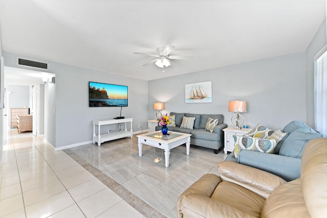 tiled living room with ceiling fan