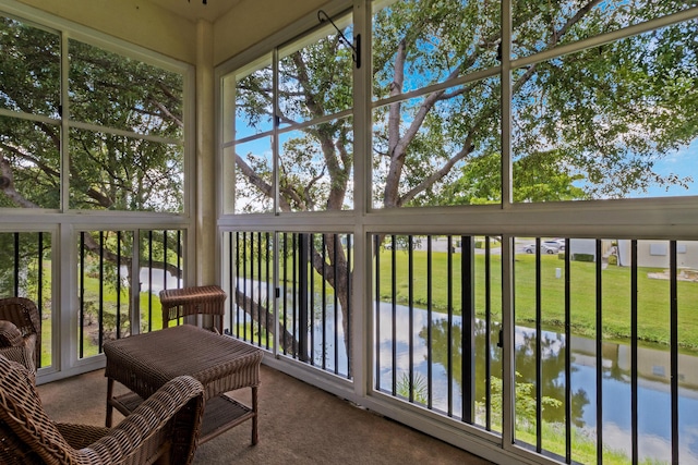 sunroom / solarium with a water view