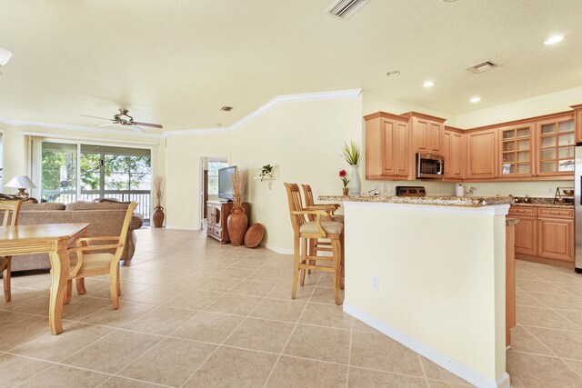 living room with ceiling fan, ornamental molding, and light tile patterned flooring