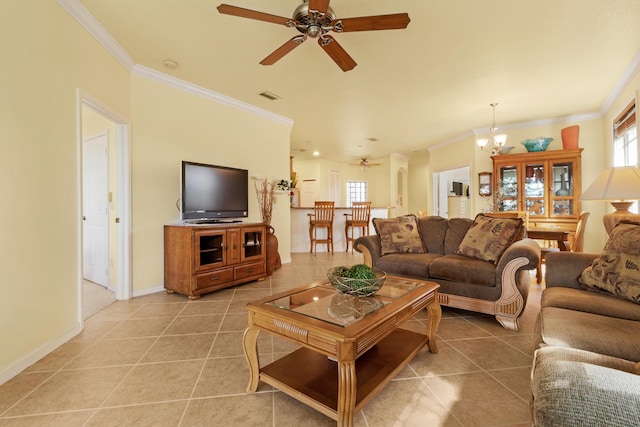 living room featuring ceiling fan with notable chandelier, tile patterned flooring, and ornamental molding