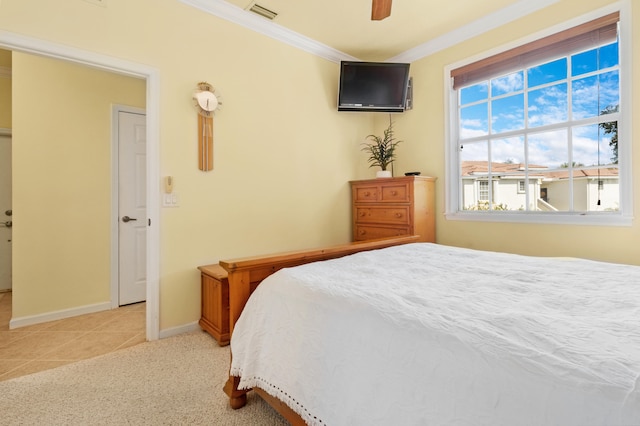 bedroom with ceiling fan, ornamental molding, and light tile patterned flooring