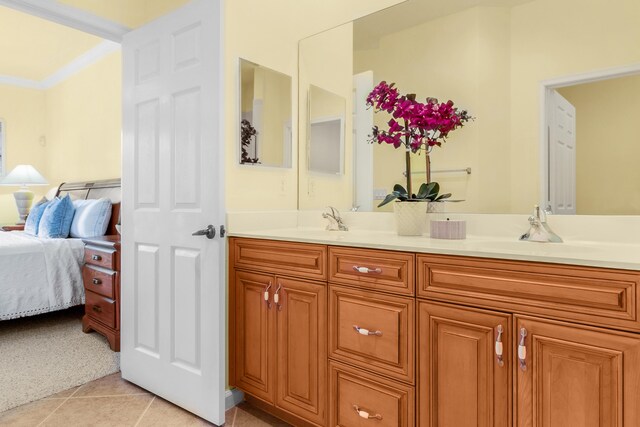 bathroom with vanity, crown molding, and tile patterned floors