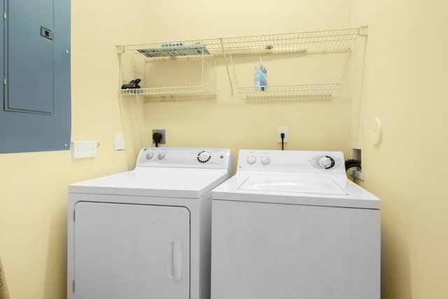 clothes washing area with electric panel and washing machine and clothes dryer