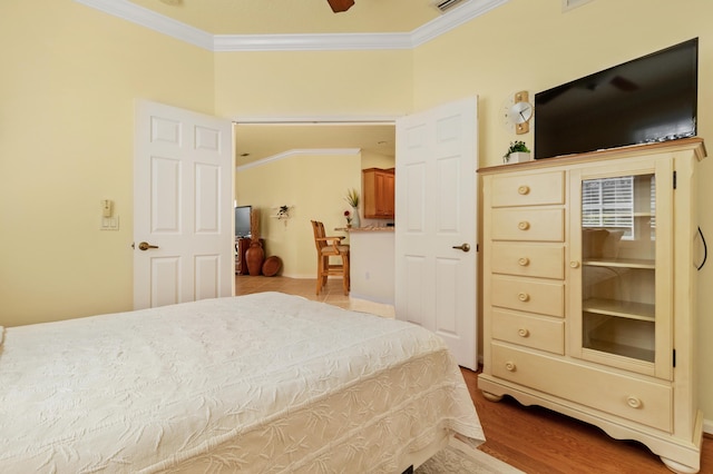 bedroom with crown molding and light hardwood / wood-style flooring