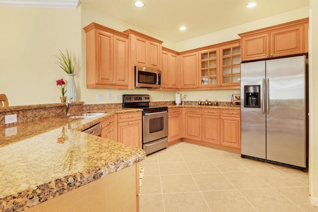 kitchen featuring sink, light stone countertops, appliances with stainless steel finishes, light tile patterned floors, and light brown cabinetry