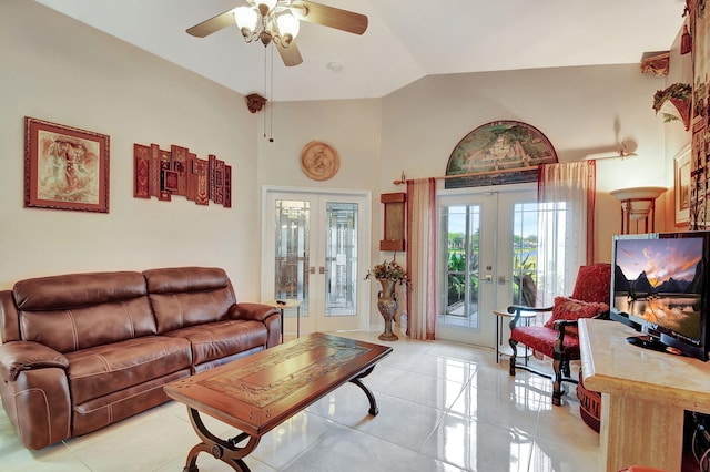 tiled living room featuring french doors, ceiling fan, and lofted ceiling