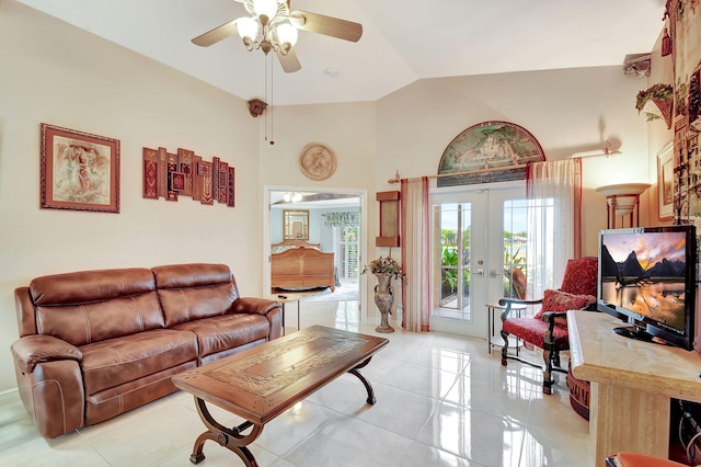 tiled living room featuring ceiling fan, french doors, and lofted ceiling