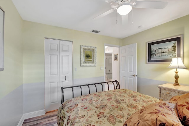 bedroom featuring ceiling fan, a closet, and hardwood / wood-style flooring