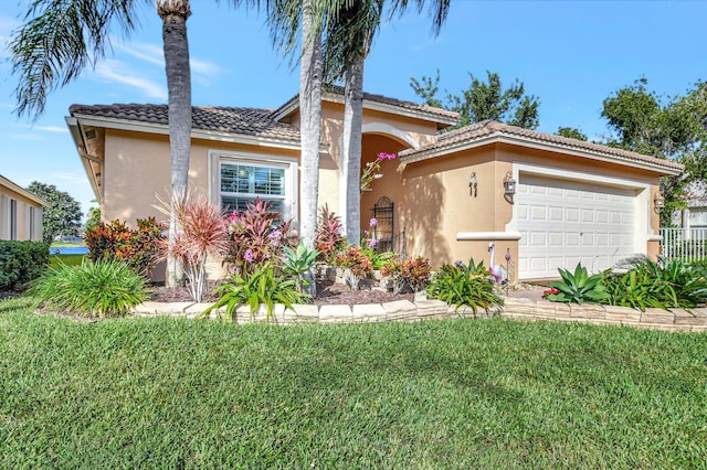 mediterranean / spanish house with a garage and a front yard