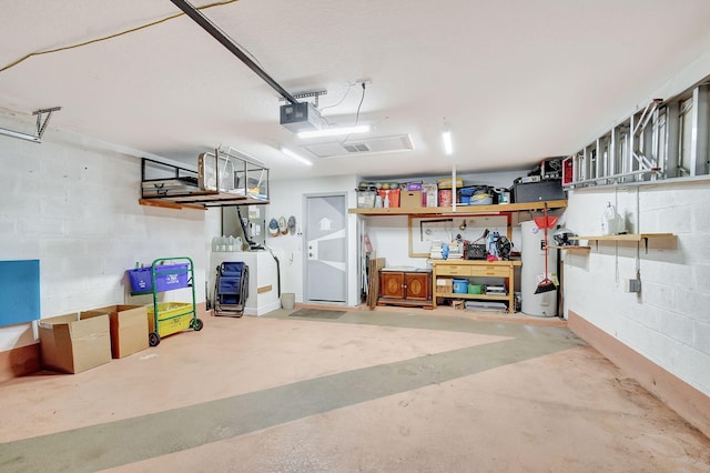 garage featuring water heater and a garage door opener