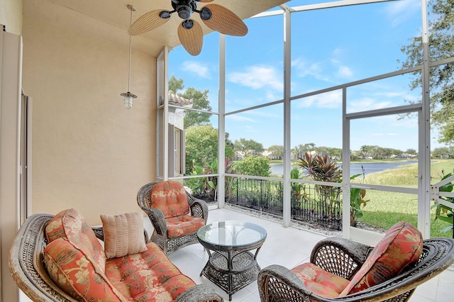 sunroom / solarium featuring ceiling fan