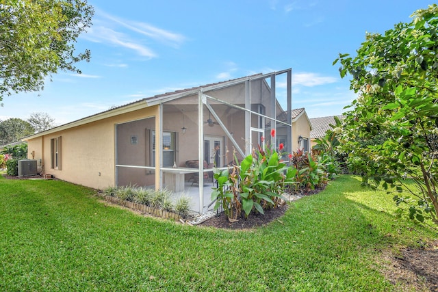 view of side of property featuring a lawn, a patio, and central AC