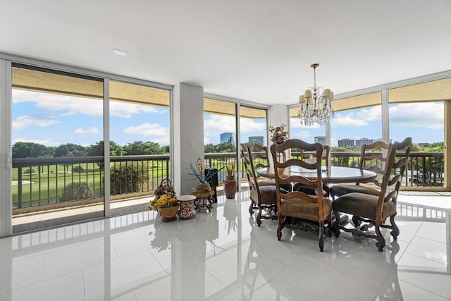 sunroom featuring a chandelier and a wealth of natural light