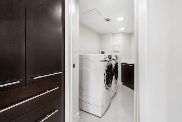 washroom with washer and clothes dryer and light tile patterned flooring