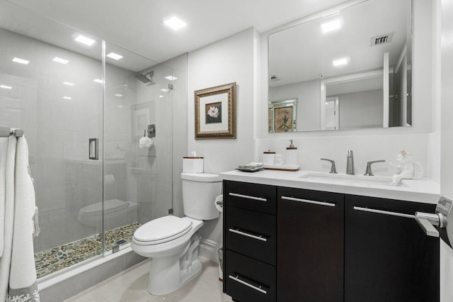 bathroom with vanity, toilet, and an enclosed shower