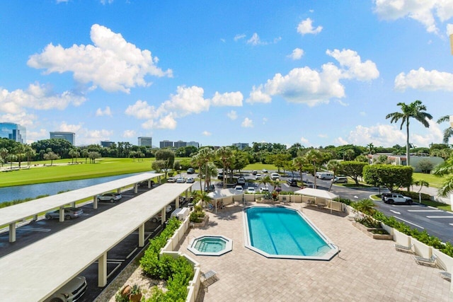 view of swimming pool with a patio and a water view