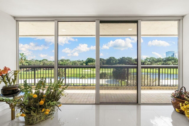 interior space featuring tile patterned floors and a water view