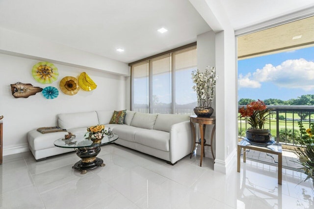 tiled living room featuring a wall of windows